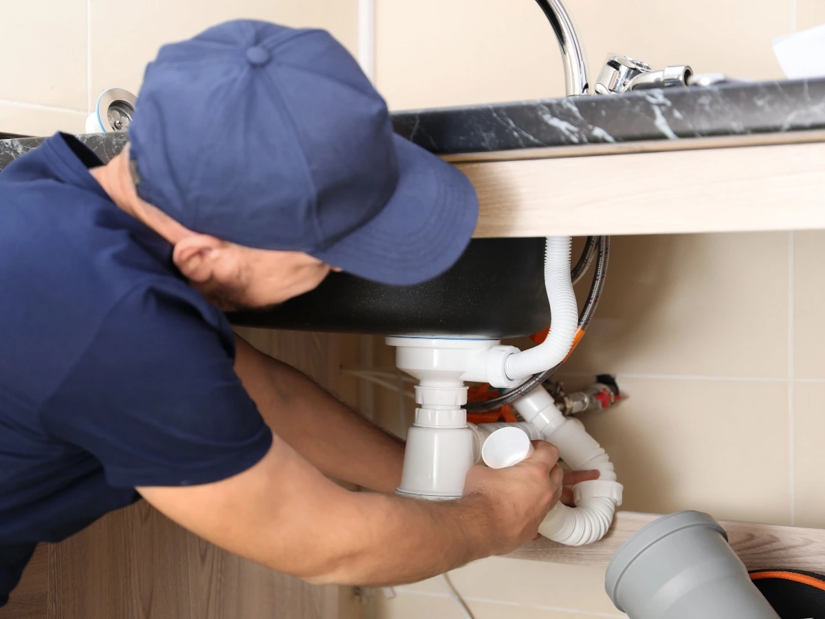 Done Rite professional plumber working on replacing damaged pipes on a residential house in Tucson