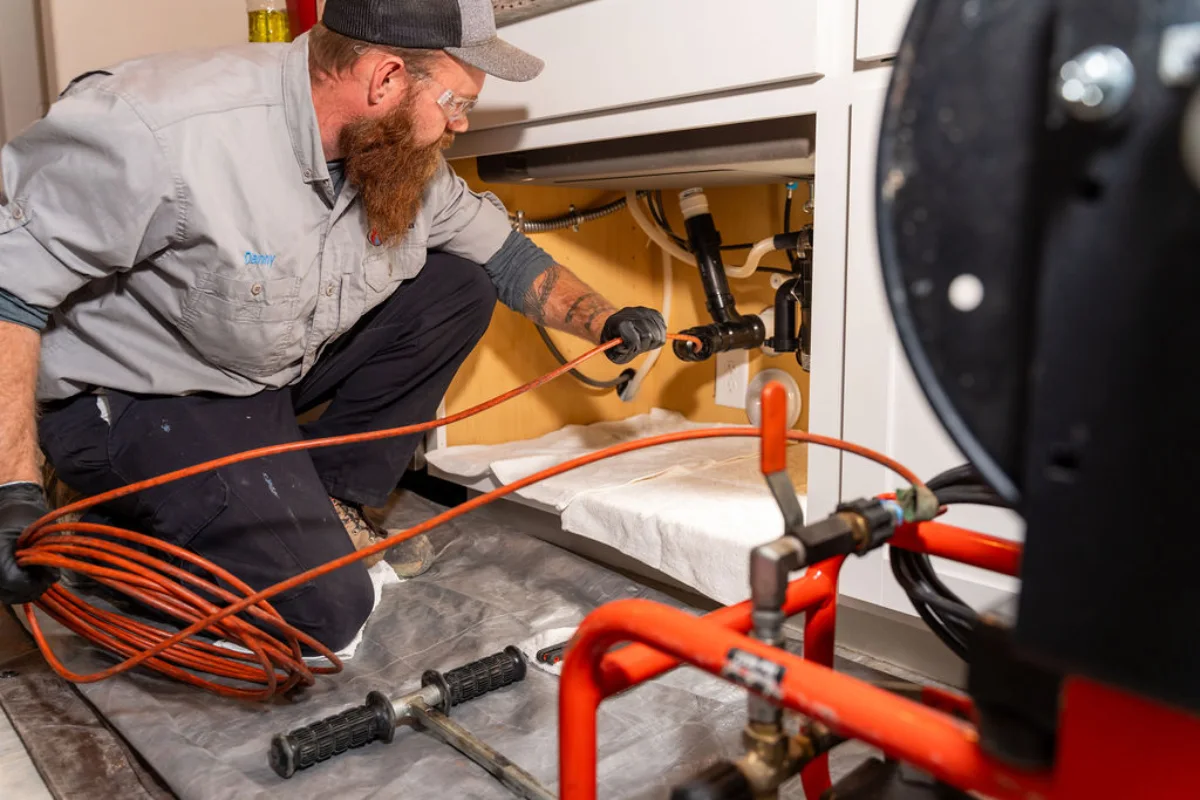 emergency plumbing repair in Tucson, Done Rite Services technician working under the sink