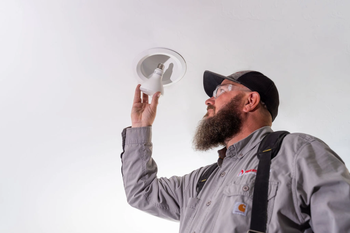 Image of Done Rite electrician in Tucson installing lightbulb