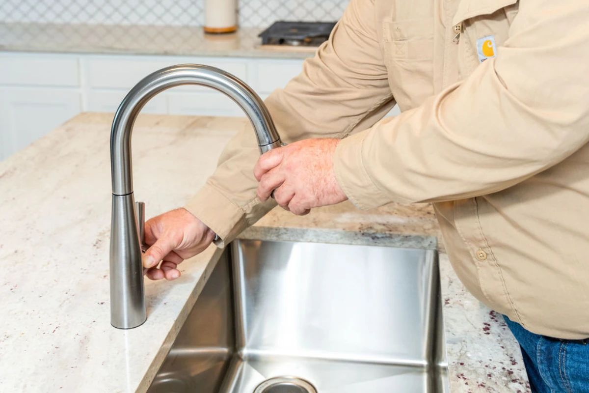 Expert plumber from Done Rite Services in Tucson skillfully repairing a leaky faucet to prevent water wastage.