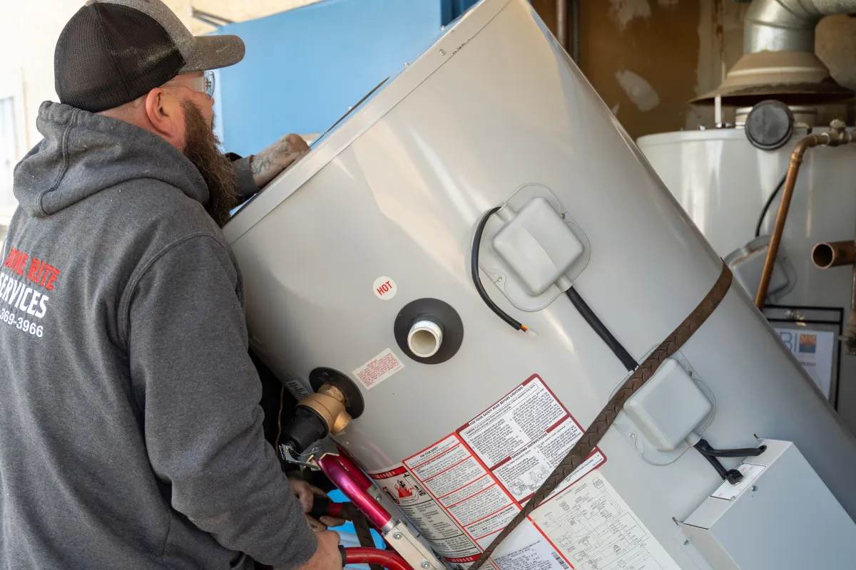 Done Rite Services expert plumber installing a replacement water heater.