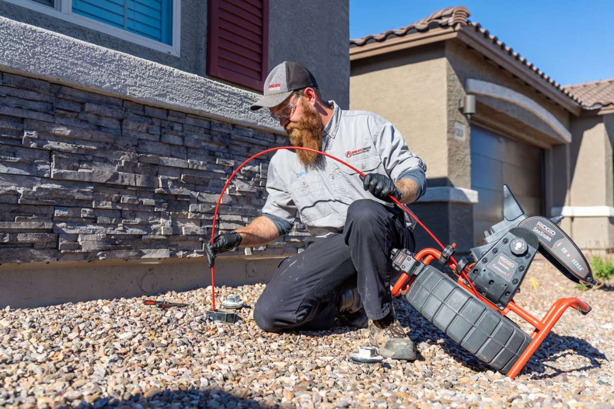 Done Rite Services professional plumber inspecting a sewer line for repair.