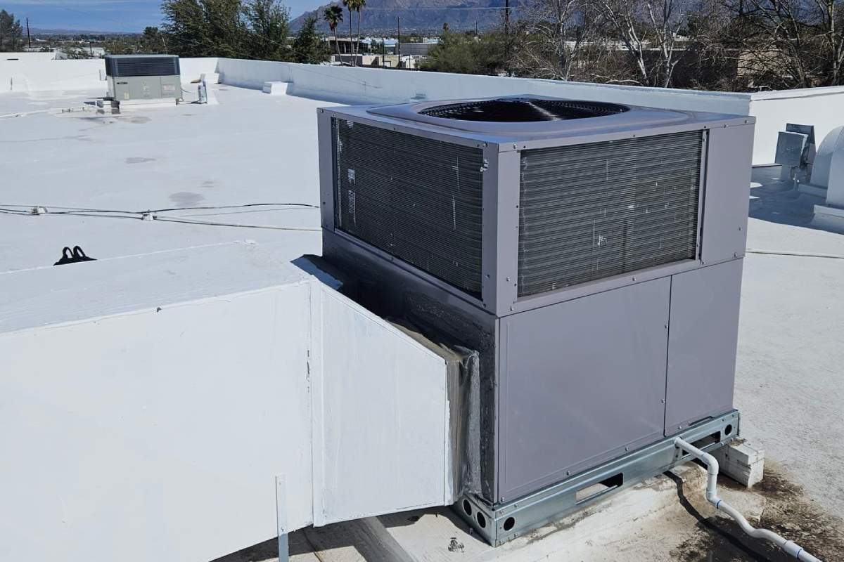 Done Rite Services technicians working on the installation of an air conditioning unit on a commercial building roof in Catalina Foothills.