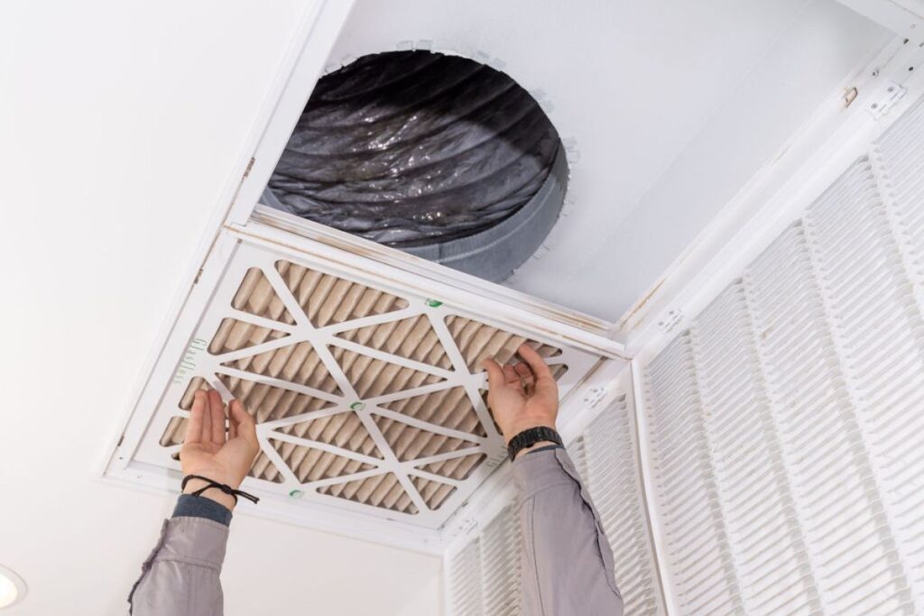 Done Rite Services HVAC expert replacing air filters, showing how to determine the best time for replacement.