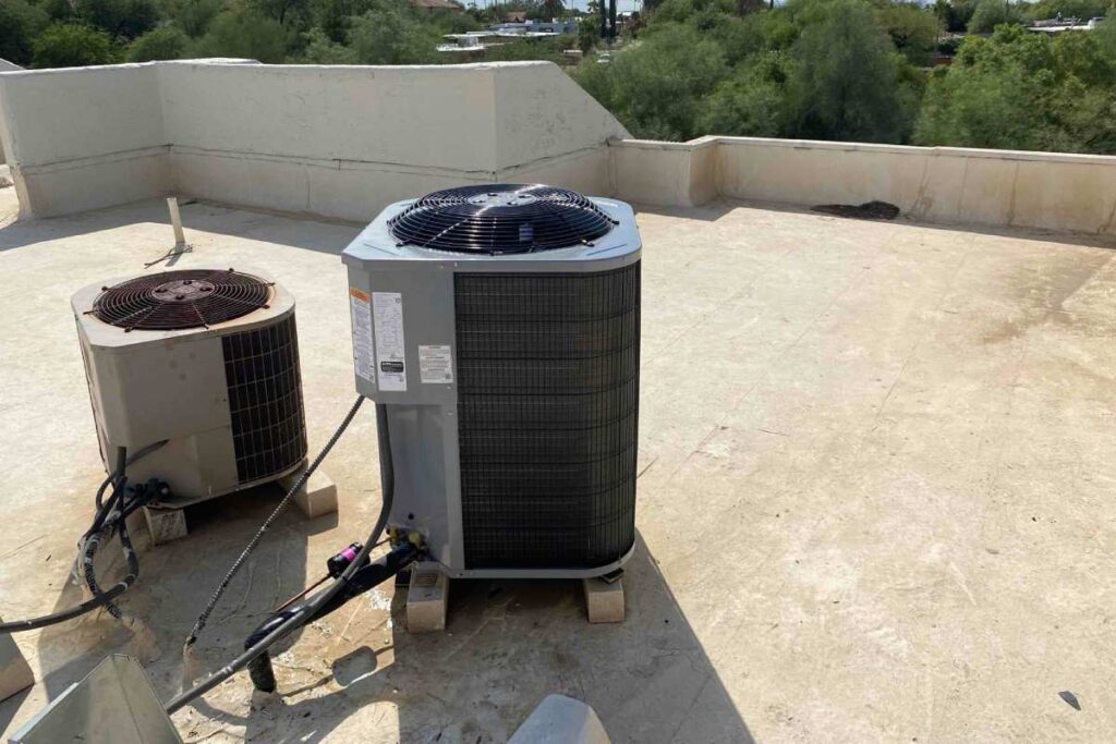 New air conditioning unit installed next to the old one, discussing the cost of AC replacement.