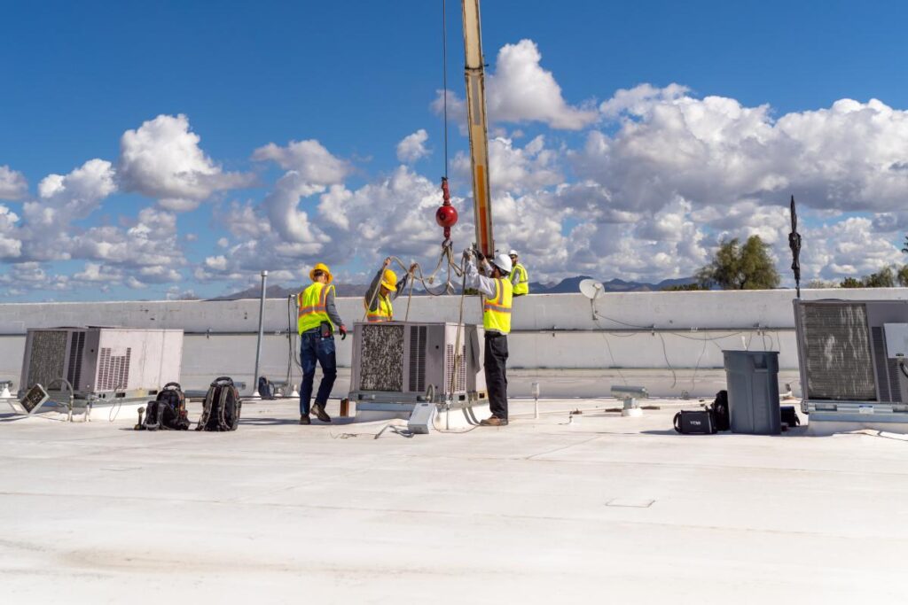 Done Rite Services HVAC experts on the roof installing a new AC unit, highlighting the importance of professional AC installation.