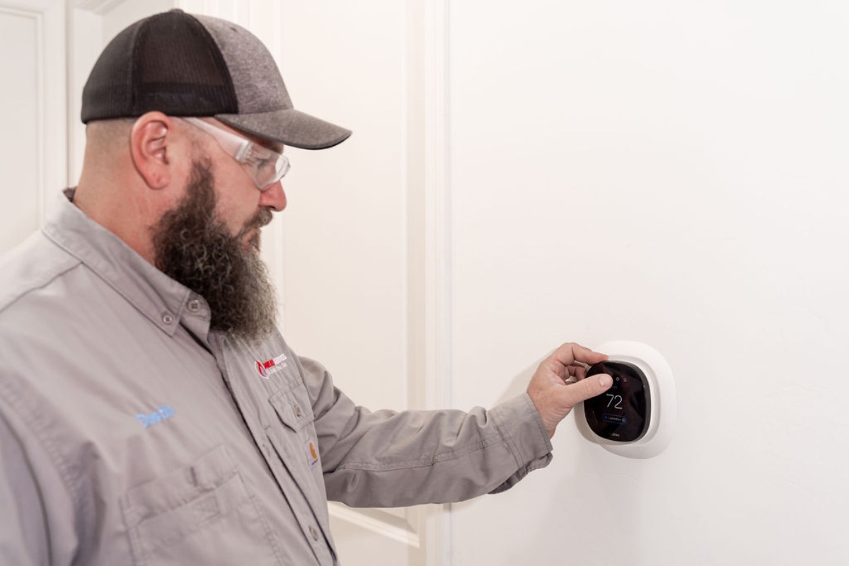 Done Rite Services technician placing a thermostat during an air conditioning installation in Catalina Foothills.