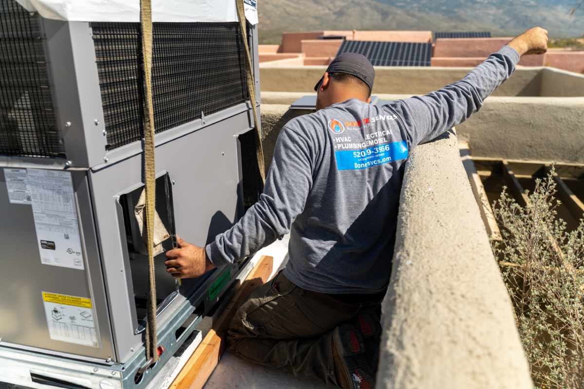 Done Rite Services HVAC technician working on air conditioning repair on the roof of a commercial building in Sahuarita.