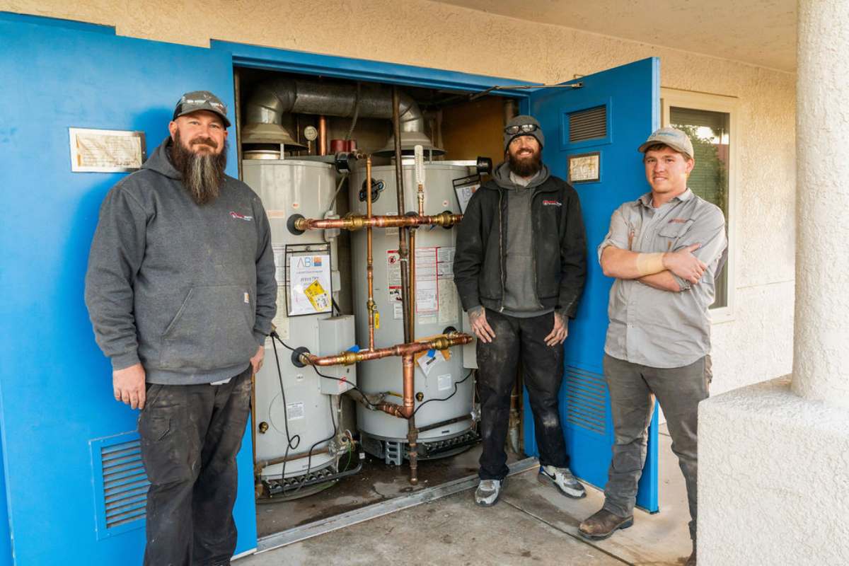 Done Rite Services plumbers standing next to a newly installed water heater in Oro Valley.