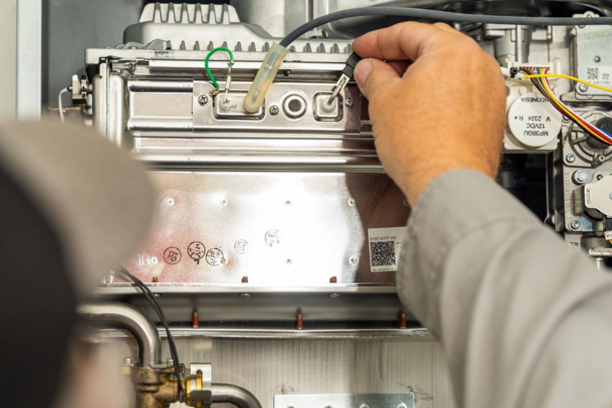 Done Rite Services technicians carefully installing a tankless water heater in Tucson.