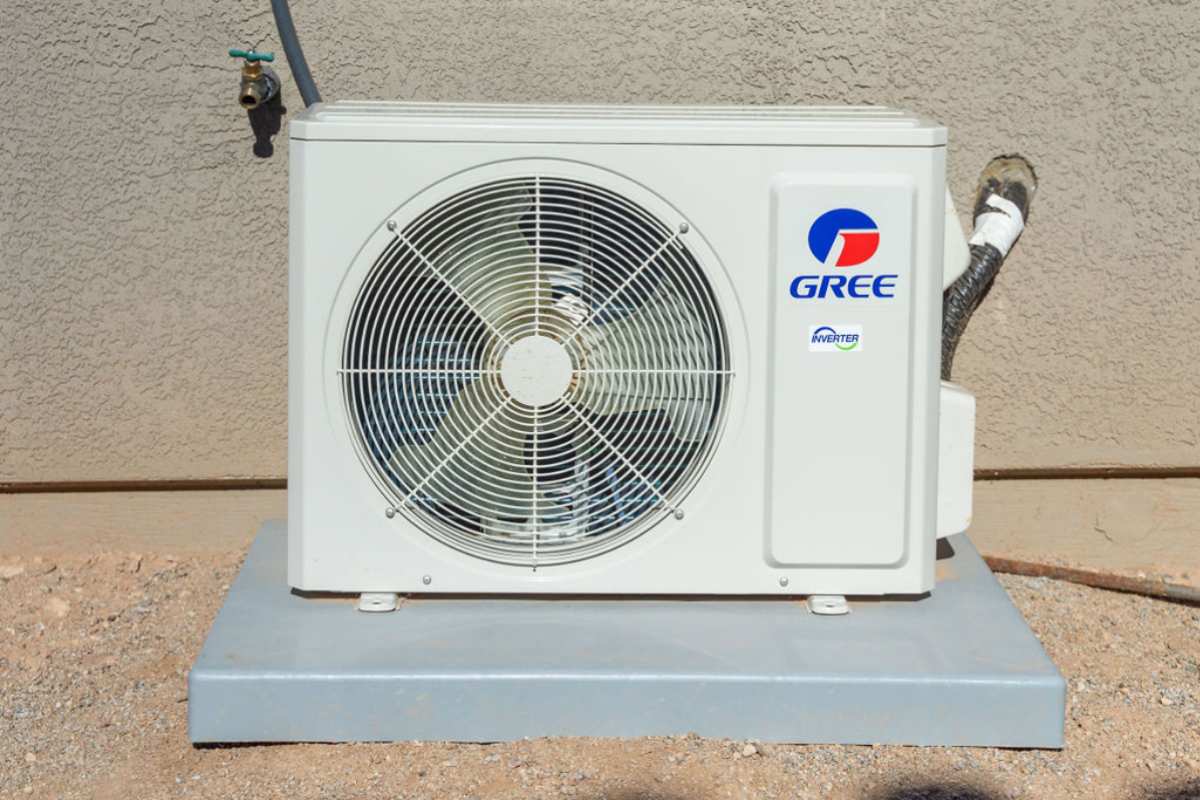 Newly installed outdoor unit of a ductless mini split system mounted on a concrete pad.