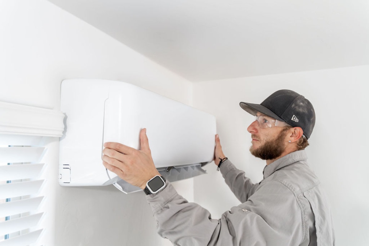 Done Rite Services technician installing a ductless mini-split system in a Tucson residence.