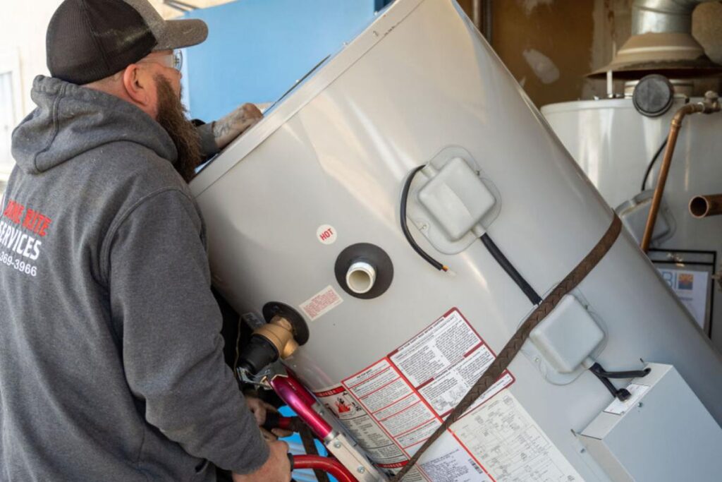 Done Rite Services expert plumber performing installation of a replacement water heater.