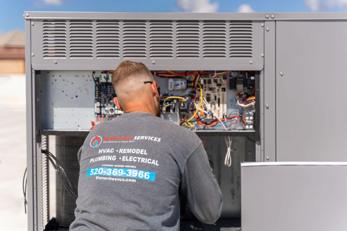 HVAC expert from Done Rite Services performing AC repairs on a rooftop in Tucson.