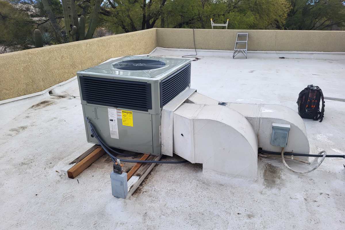 Air conditioning system on a rooftop in Tucson undergoing repair work.