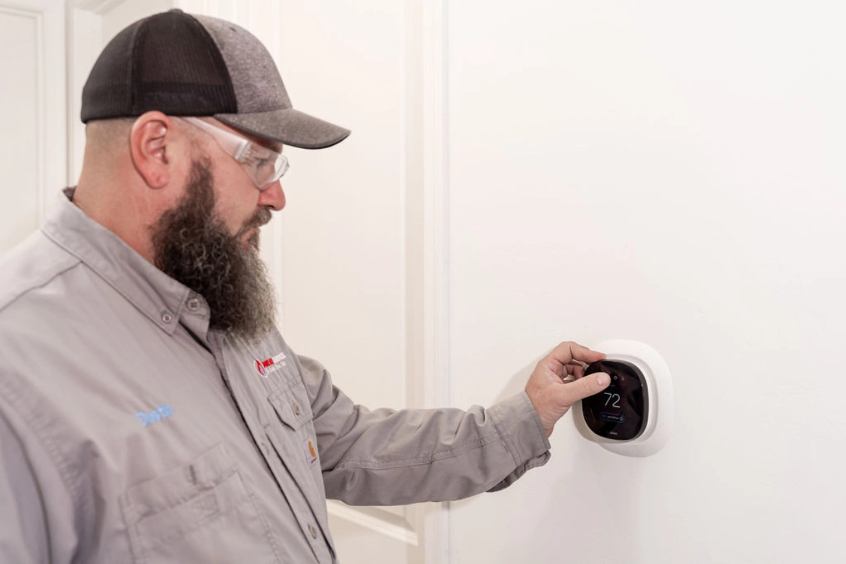 ac-installation-technician-placing-thermostat-Catalina-Foothills Done Rite AC installation technician placing a thermostat in Tucson